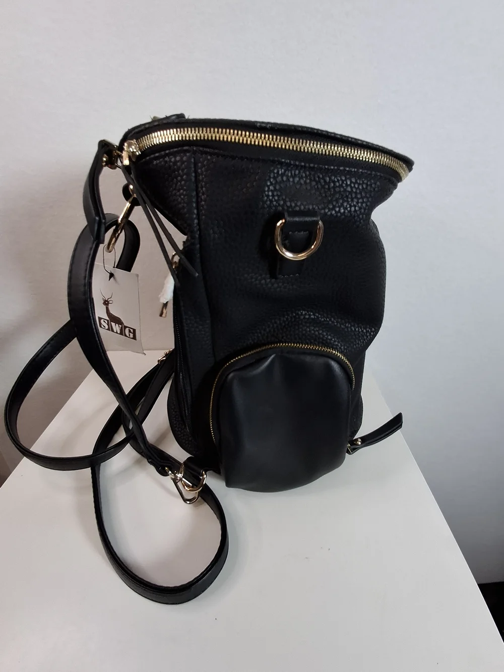 SWG Black Pebbled Sling Barrel Backpack with Gold Accents